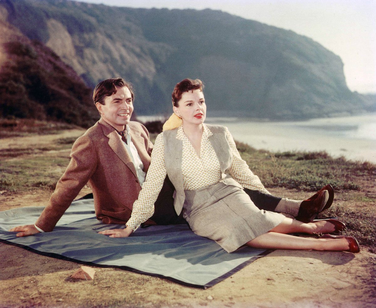 Judy Garland and James Mason laying on a blanket in the movie 'A Star Is Born', 1954, Photo Credit: George’s Classic Hollywood(GP)/X