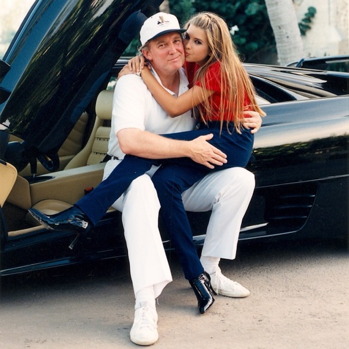 Young Ivanka Trump sitting in her dad Donald Trump's lap in a Ferrari while giving him a kiss on the cheek, Photo Credit: ivankatrump/Instagram
