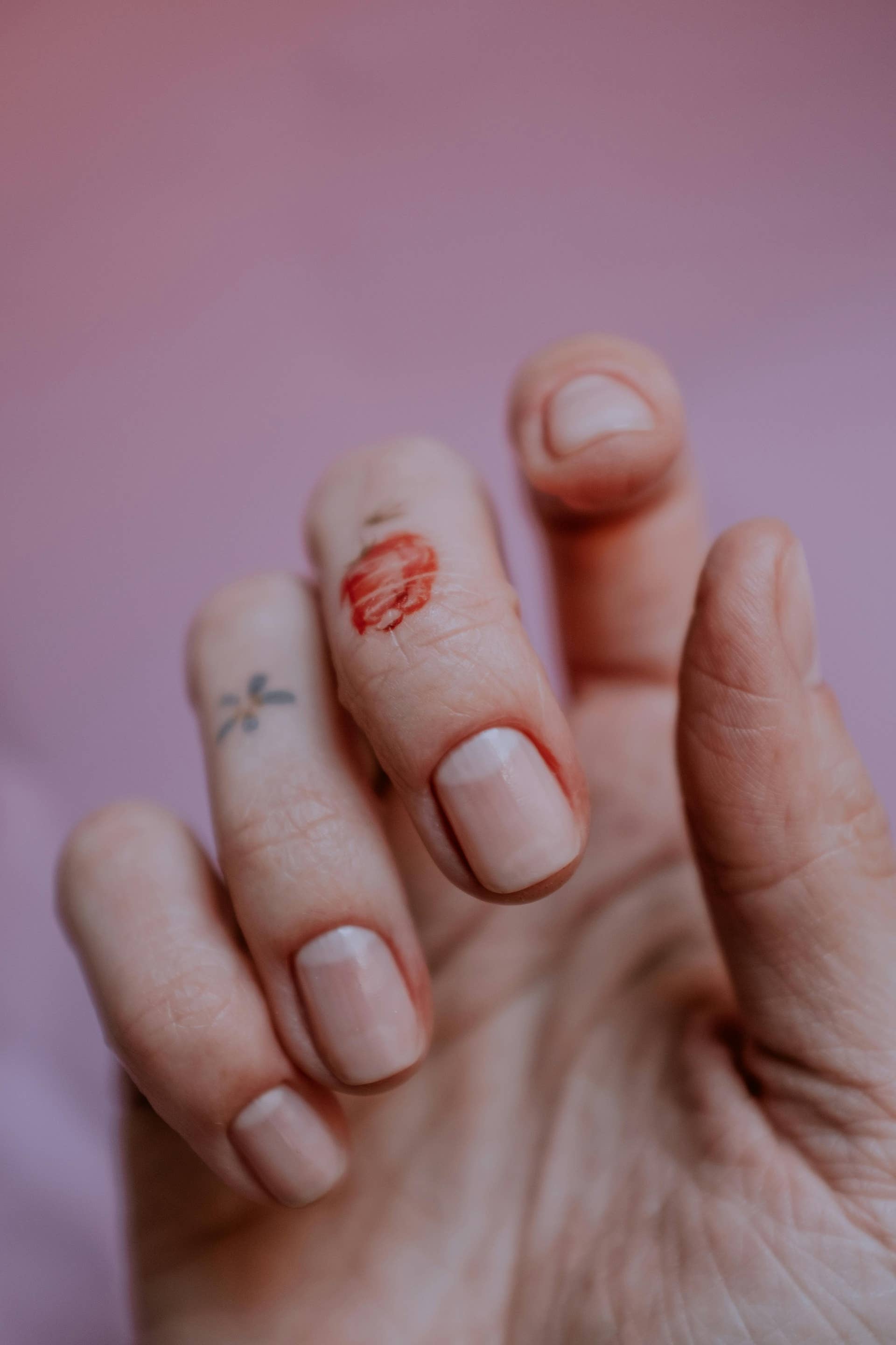 Close-Up Photo of a Person's Fingers Against a Pink Background, Photo Credit: Pexels
