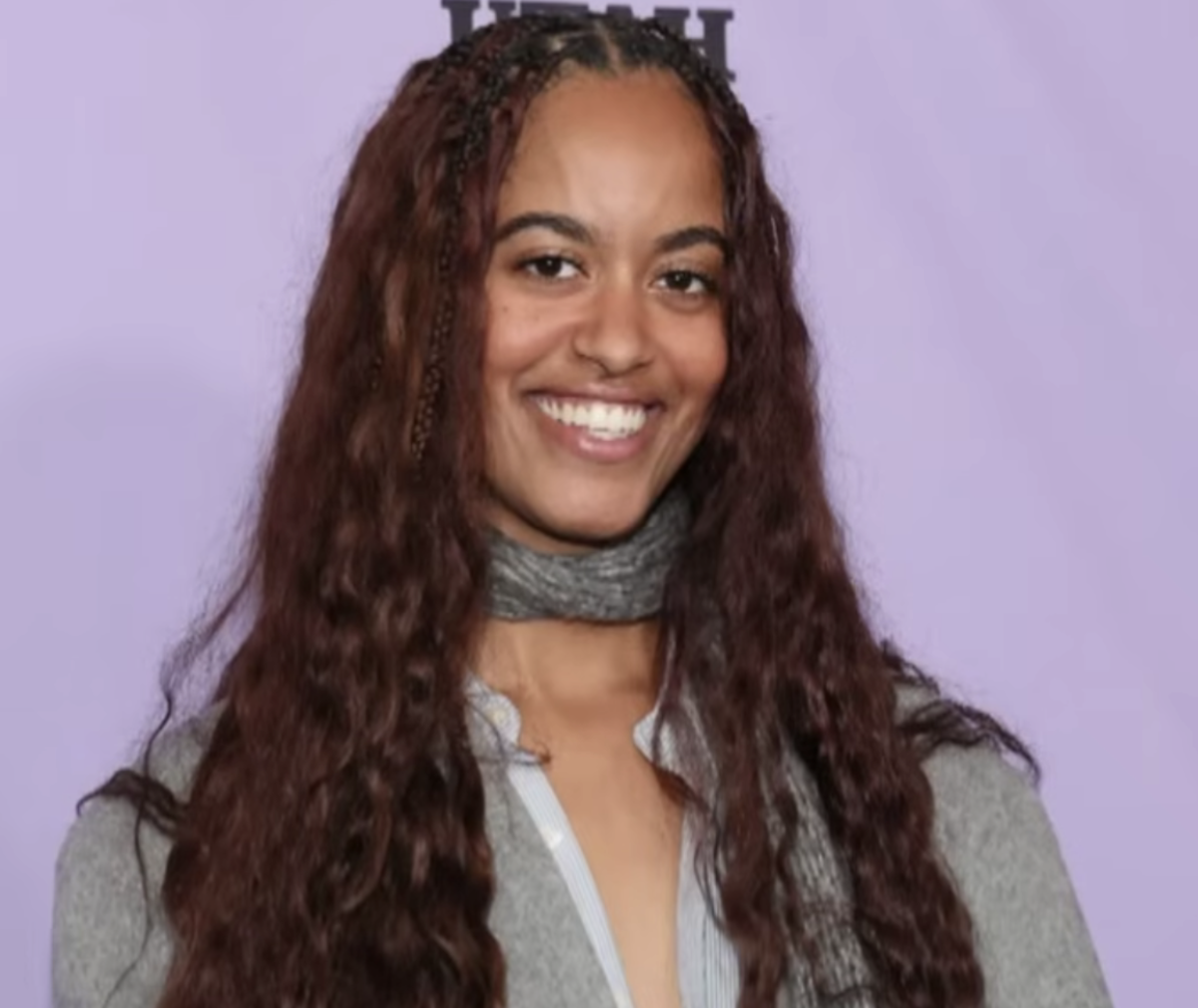 Malia Ann, formerly known as Malia Obama, smiling at a red carpet event, Photo Credit: Entertainment Tonight/Youtube