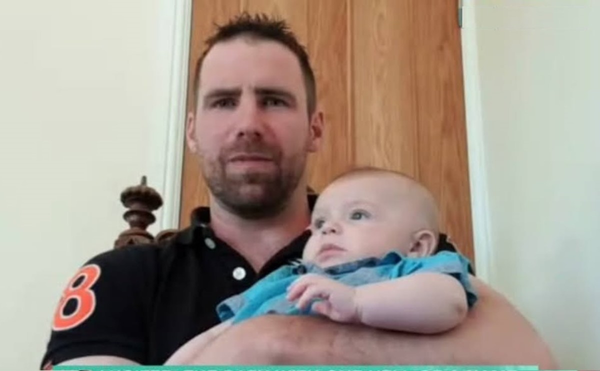 Dan Sheldon holding his baby son Lucifer in an interview with ITV morning show, Photo Credit: hurumacharles/Instagram