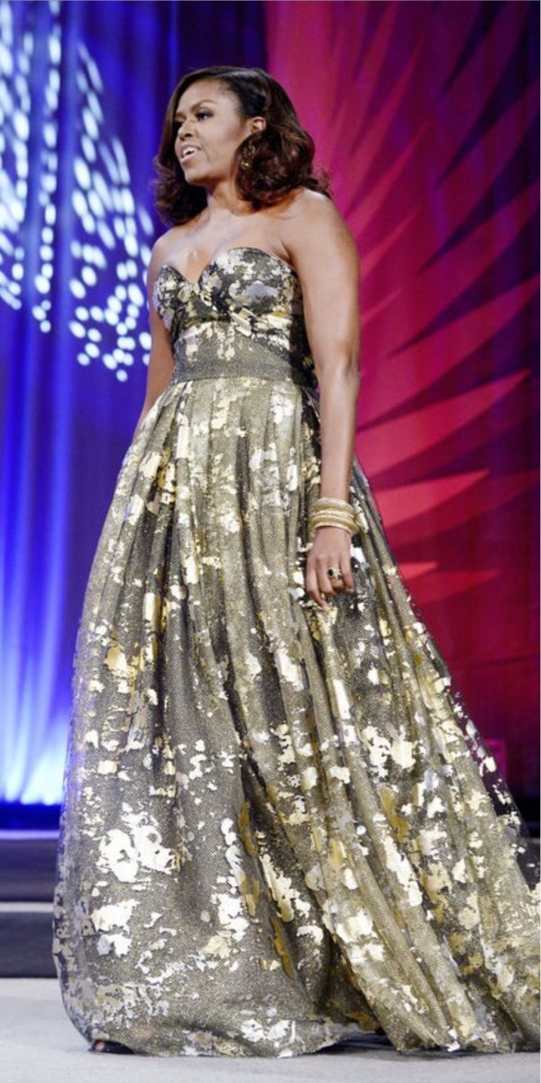 Michelle Obama wearing a strapless black and gold gown at the Congressional Black Caucus dinner, 2016, Photo Credit: Victoria Haddock/X