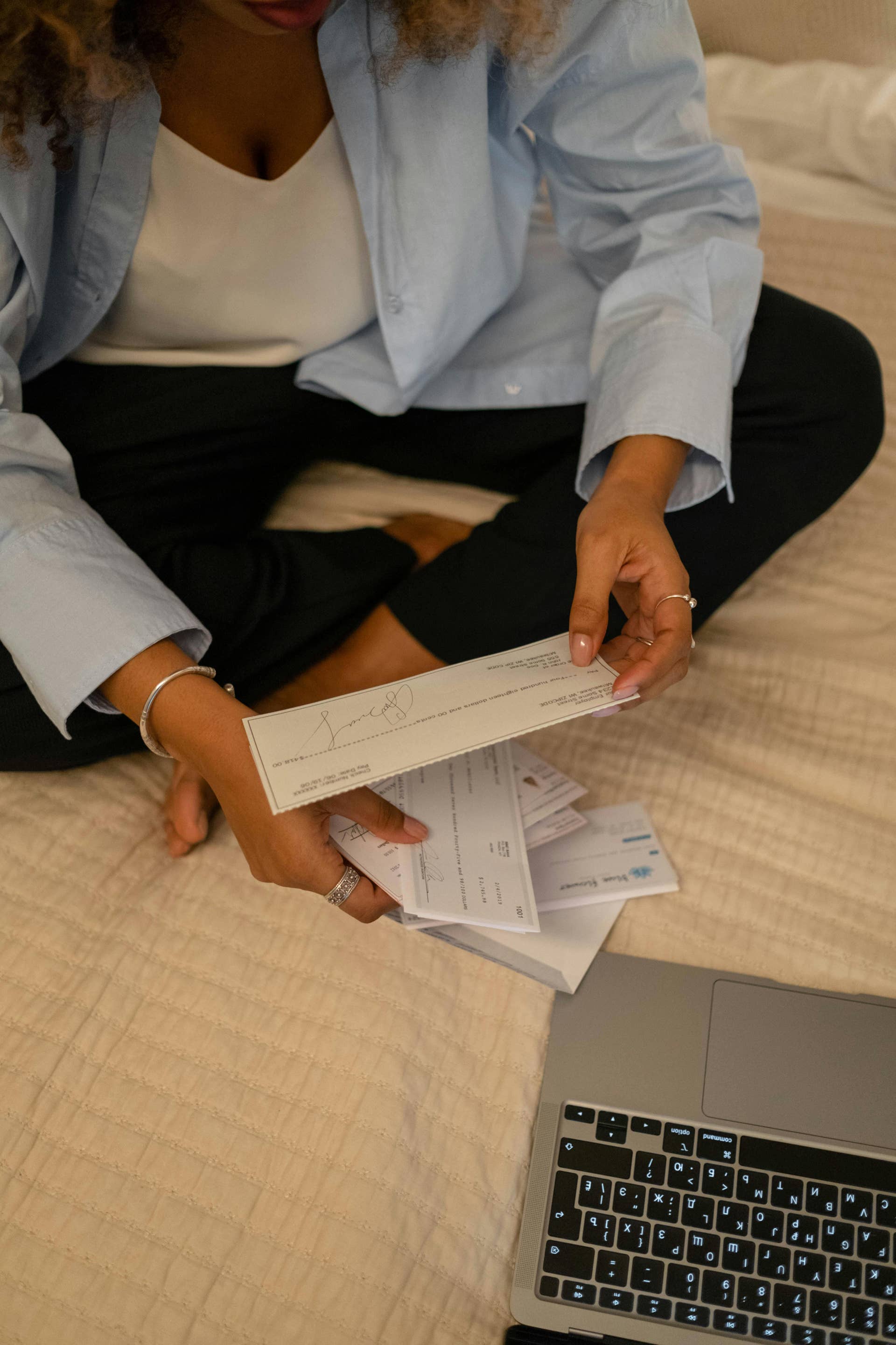 A Woman Holding a Check, Photo Credit: Pexels