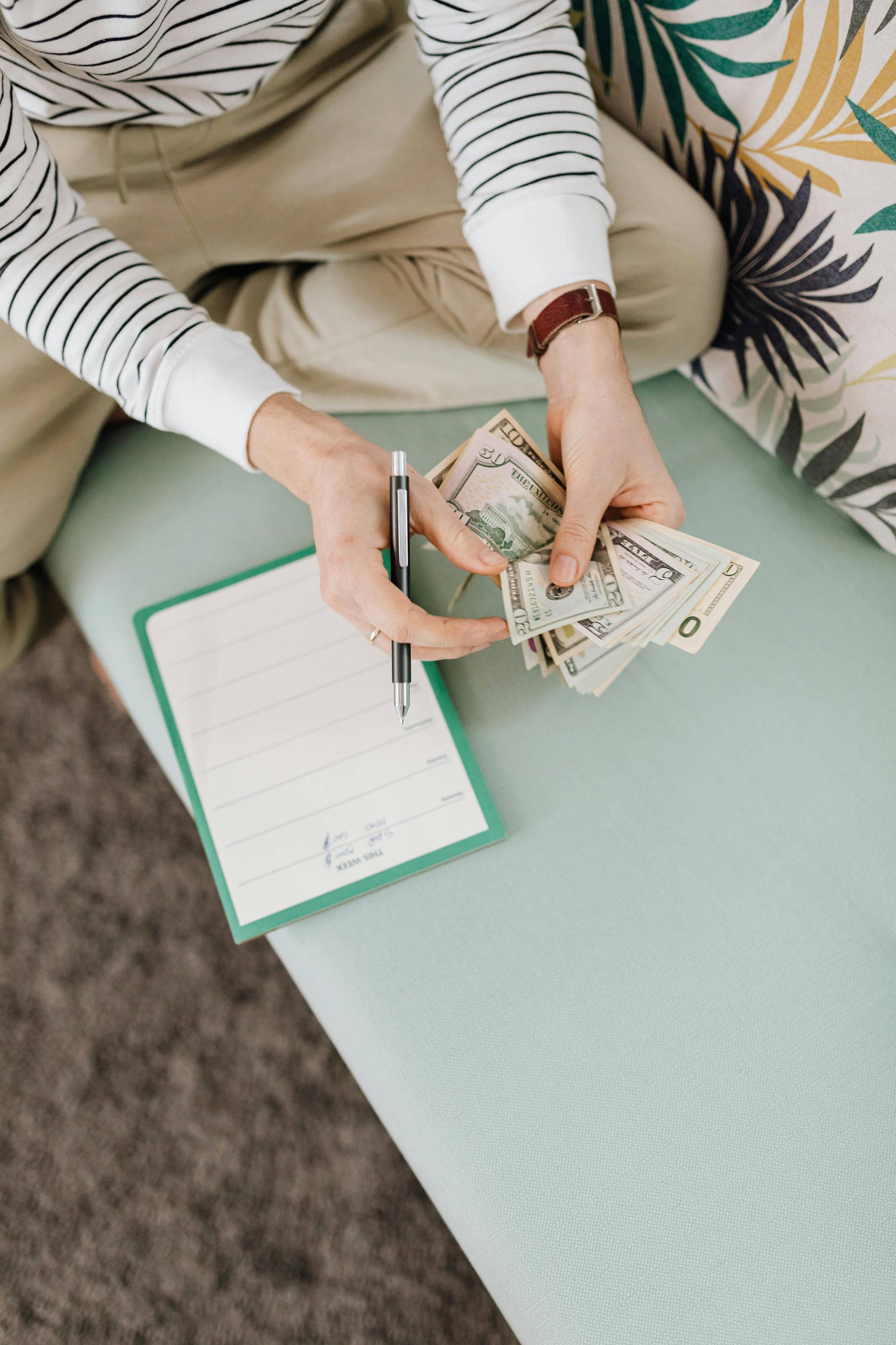 Person Counting Money While Holding a Pen, Photo Credit: Pexels