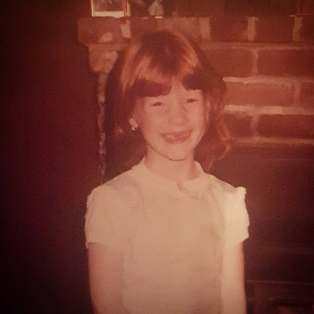 Jessica Chastain smiling at the camera as a 9 year old girl, Photo Credit: